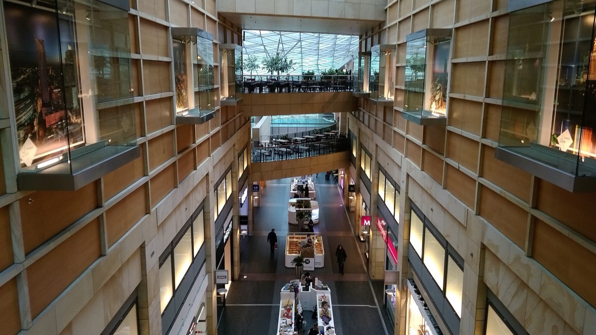 The wavy glass roof and open atrium of the Złote Tarasy shopping center in central Warsaw.
