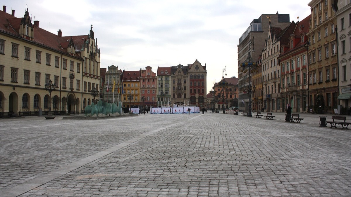 Wrocław's Market Square with the Gothic Old Town Hall and rows of colorful gabled townhouses.